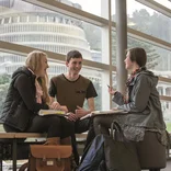 Students studying with Beehive in the background